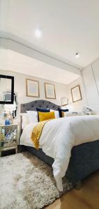 a bedroom with a large bed and a rug at Ellipse Luxury High Rise Apartment in Midrand