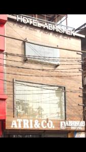 a building with a sign on the side of it at Hotel Abhishek in Jhānsi