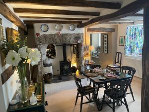 a dining room with a table and a fireplace at Low Fell in Ulverston