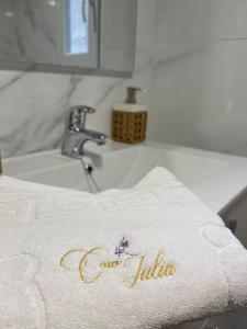 a towel with the word godzilla sitting on a sink at Casa iulia in Haro