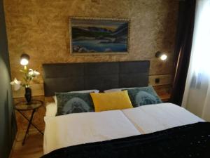 a bedroom with a bed with yellow and blue pillows at LES CHALET Kranjska Gora I in Kranjska Gora