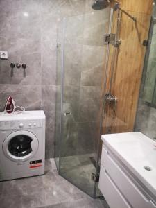 a shower with a washing machine in a bathroom at NEW STUDIO in ARCADIA in Odesa