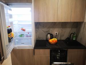 an open refrigerator with a bowl of fruit on a counter at NEW STUDIO in ARCADIA in Odesa
