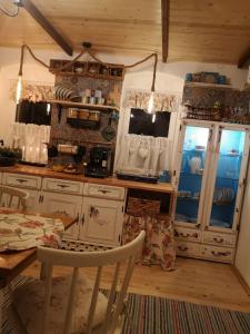 a kitchen with a table and a dining room at The Little Blue House in Reşiţa +59 photos