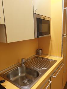 a kitchen with a sink and a microwave at Ale's residence in Casal Palocco