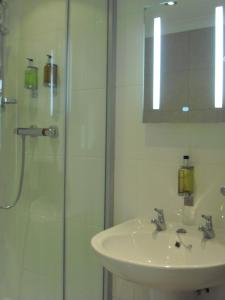 a bathroom with a sink and a glass shower at The Engine Shed in Weston-super-Mare