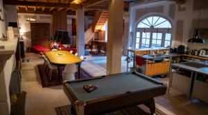 a room with a pool table in a kitchen at Le prieuré de Sainte Vertu in Sainte-Vertu