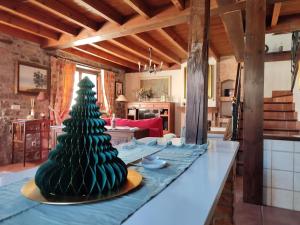 a christmas tree on a table in a living room at La Quintana de Doña Leonor in Arriondas