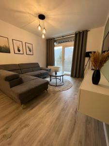 a living room with a couch and a table at Wald-Liebe-Fewo in Bad Harzburg