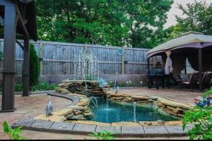 a backyard with a pond with two birds in it at 1Min to Percy Priest Lake 2 Masters Quiet Family Home in La Vergne