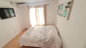 a bedroom with a bed and a tv on a wall at Vicky House in La Falda