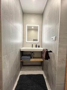 a bathroom with a sink and a mirror at Apartmány Mammut a Yetti-Šafran Donovaly in Donovaly +72 photos