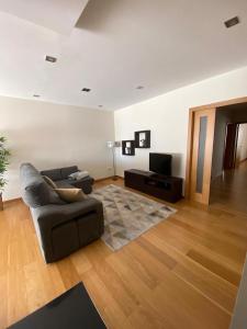 a living room with a couch and a television at Villa CL in Vila do Conde