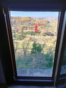 a window in a room with a view of a field at La mansarda del Sacro Bosco in Bomarzo
