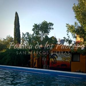 a swimming pool in front of a villa at Posada de los Padres - LOS OLIVOS in San Marcos Sierras