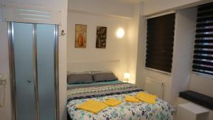 a bedroom with a bed with yellow towels on it at TRIO Suite Yenikapı Old City in Istanbul