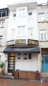 a white building with a sign that reads hit trio suite at TRIO Suite Yenikapı Old City in Istanbul