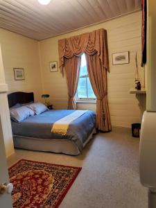 
a bedroom with a bed and a window at Stay at Tilba in Central Tilba
