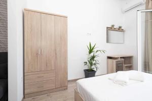 a bedroom with a large wooden cabinet and a bed at Giorgos' House Gialova in Gialova