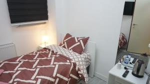 a bedroom with a bed with a comforter and pillows at TRIO Suite Yenikapı Old City in Istanbul