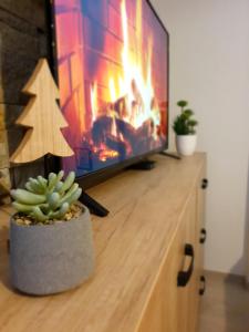 a christmas tree on a entertainment center with a television at Milmari Lux Apartment N74 Kopaonik in Kopaonik