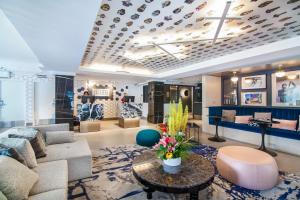 a living room with a couch and a table at Hotel Belmont Vancouver - MGallery Collection in Vancouver