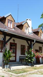 a house with a wooden roof and some plants at Penzion U Houšků in Stráž nad Nežárkou