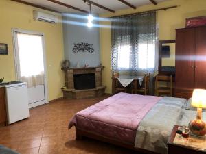 A bed or beds in a room at Alexandros Guesthouse