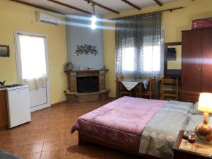 A bed or beds in a room at Alexandros Guesthouse