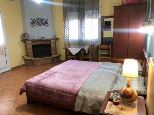 A bed or beds in a room at Alexandros Guesthouse