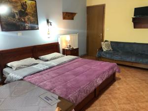 A bed or beds in a room at Alexandros Guesthouse