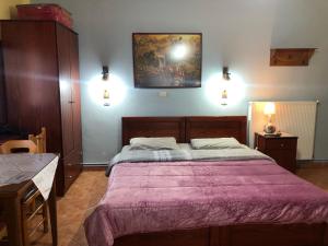 A bed or beds in a room at Alexandros Guesthouse