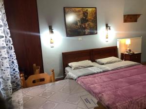 A bed or beds in a room at Alexandros Guesthouse