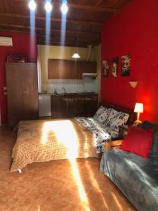 A bed or beds in a room at Alexandros Guesthouse