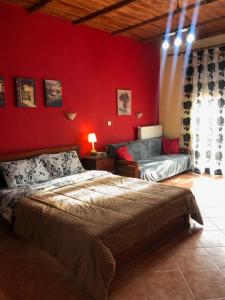 A bed or beds in a room at Alexandros Guesthouse