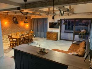 a living room with a couch and a table at Cozy House Bohot Relax, Къща за гости Бохот Релакс in Khotnitsa