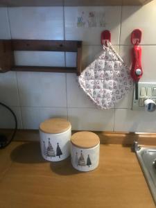 a kitchen counter with two stools and a bag at Condominio Il Rustico in Aosta