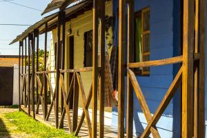 a house with a wooden fence in front of it at Cabañas Puerto Surf in Mar del Plata