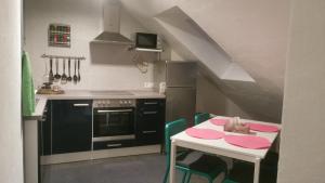 a kitchen with a table and a stove and a sink at Rimvydas Apartment in Winterberg