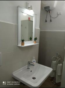 a bathroom with a sink and a mirror at Il Nido della Calandra in Tuglie +40 photos