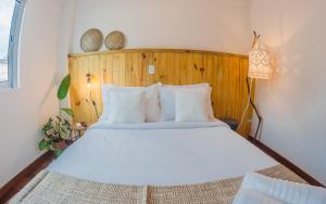 מיטה או מיטות בחדר ב-Vilarejo - Centro Histórico Ilhabela