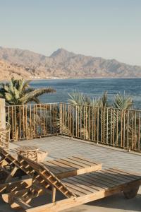 a wooden deck with a view of the ocean at Dar Dahab in Dahab