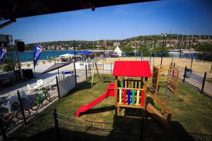 a park with a playground with a slide at MIRAMARE Romantic Experience with privat Jacuzzi - floating house in Portorož