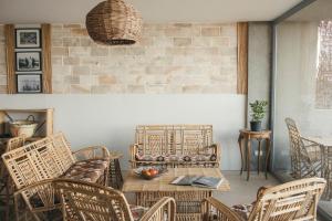 a patio with a table and chairs and a brick wall at Dar Dahab in Dahab