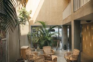 a patio with chairs and plants in a building at Dar Dahab in Dahab