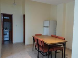 a kitchen with a table and chairs and a refrigerator at Casa Huerta in Vista Flores