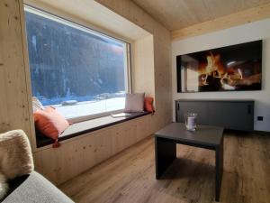 a room with a window with a bench and a table at Haus Wally in Neustift im Stubaital