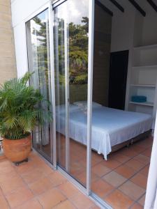 a room with a bed on a balcony at San Jeronimo Cabaña in San Jerónimo +26 photos