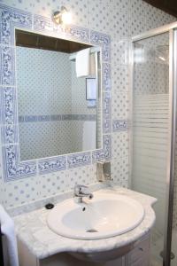 a bathroom with a sink and a mirror at Monte do Ribeiro Baço - Monsaraz in Monsaraz +42 photos