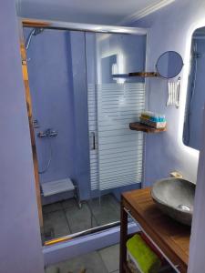 a bathroom with a glass shower with a sink at Athens Riviera apt with seaview, 15' to Acropolis in Athens